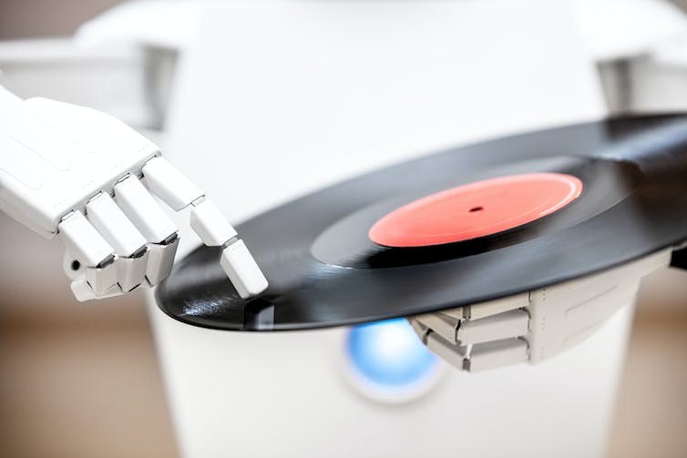 A robot holding a vinyl album