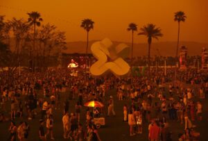 Music fans -- seen through tinted windows -- stand en masse on the lawn at Coachella 2023