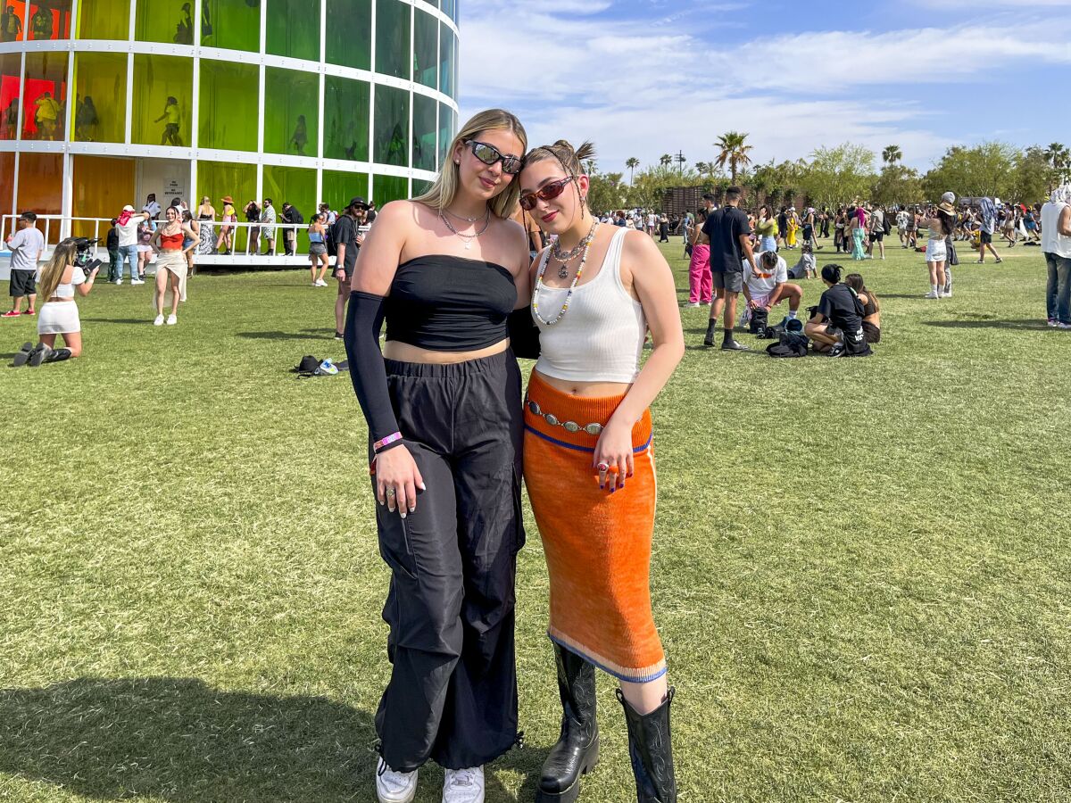 Paulina Gonzalez and Greta Knosel standing on the grass at Coachella