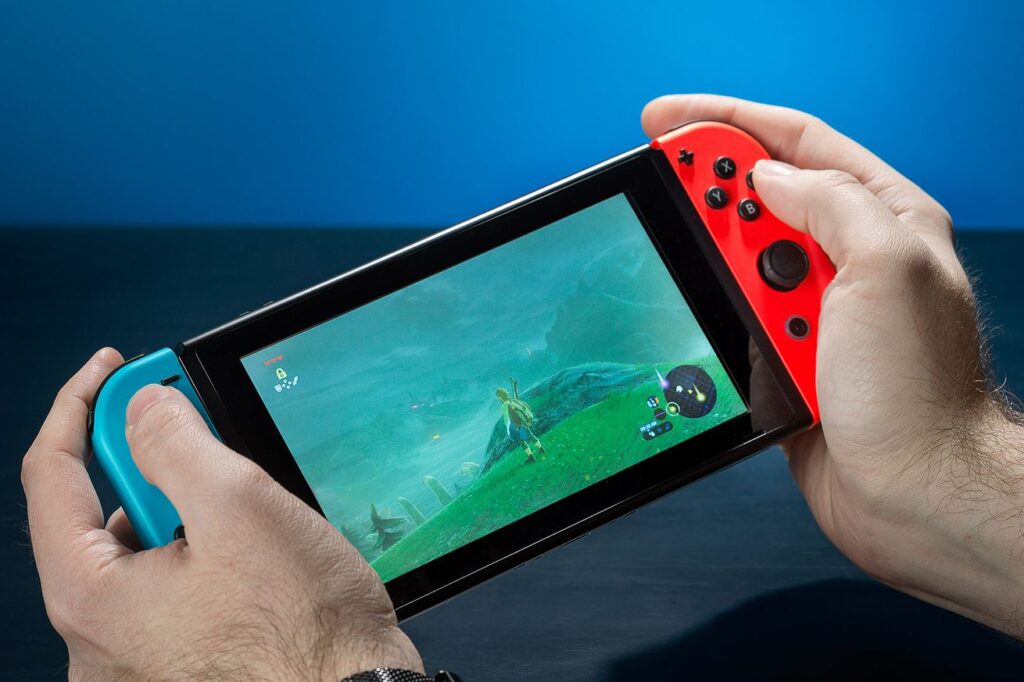 Someone playing The Legend of Zelda: Breath of the Wild on a Nintendo Switch handheld console.