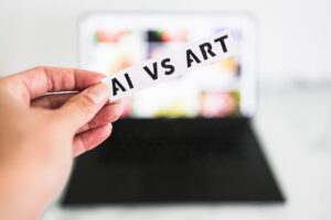 Hand holding up a piece of paper saying AI vs Art
