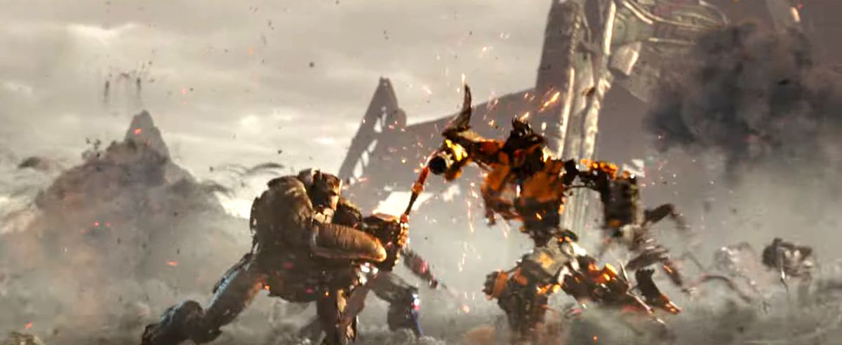 Optimus Primal in robot form battles a yellow Transformer with a spear in Transformers: Rise of the Beasts