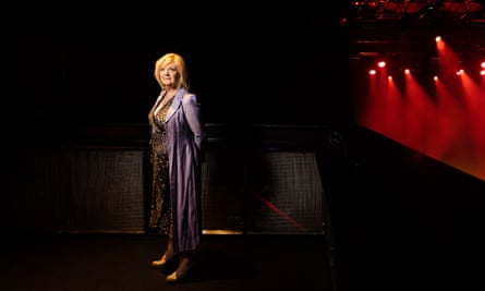 Nicki French, who appeared in Eurovision 2000, standing on a stage with spotlights behind her 