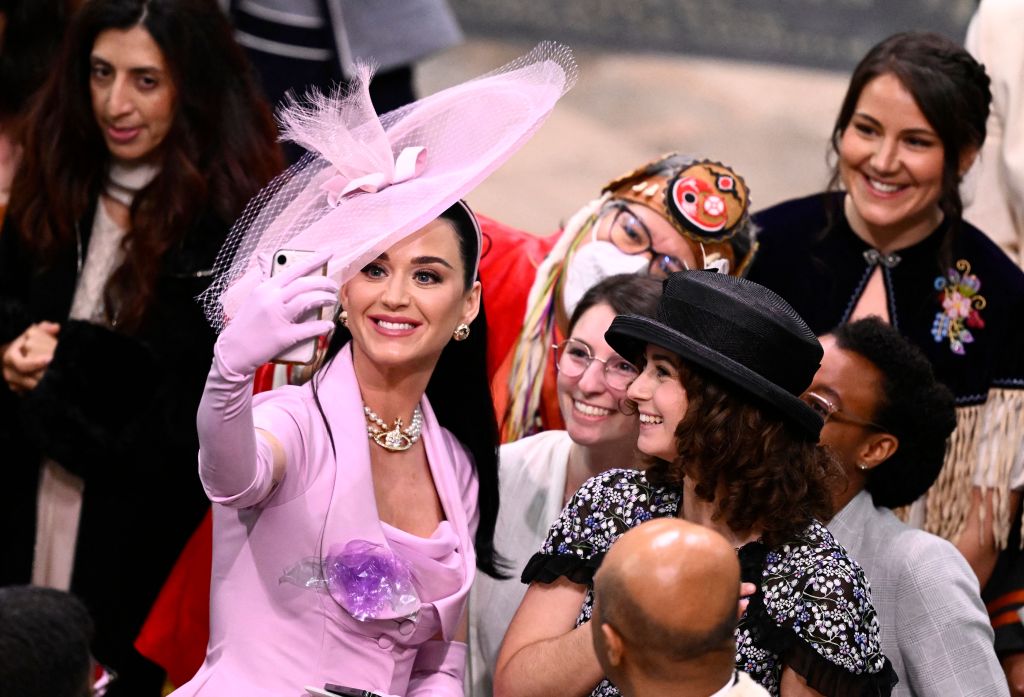 Katy Perry takes selfie photos with guests at Westminster Abbey