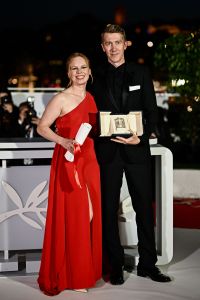Finnish actress and singer Alma Poysti (L) and Finnish actor Jussi Vatanen pose after they accepted the Jury Prize for the film "Kuolleet Lehdet" (Fallen Leaves) on behalf of Finnish director Aki Kaurismaki