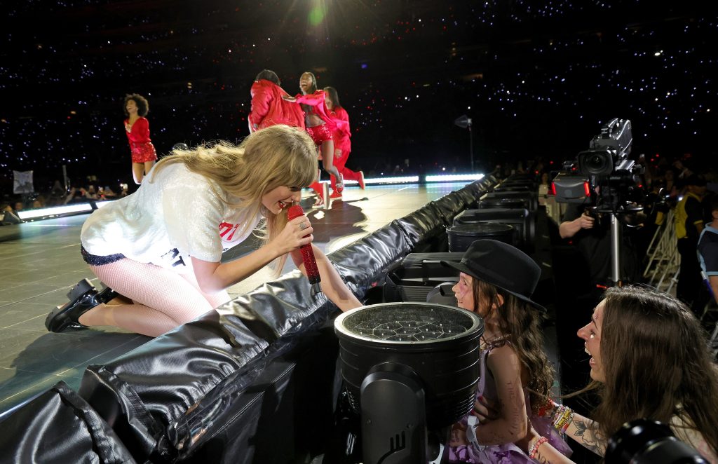Taylor Swift gives her hat to a young fan during "Taylor Swift | The Eras Tour" at MetLife Stadium on May 27, 2023 