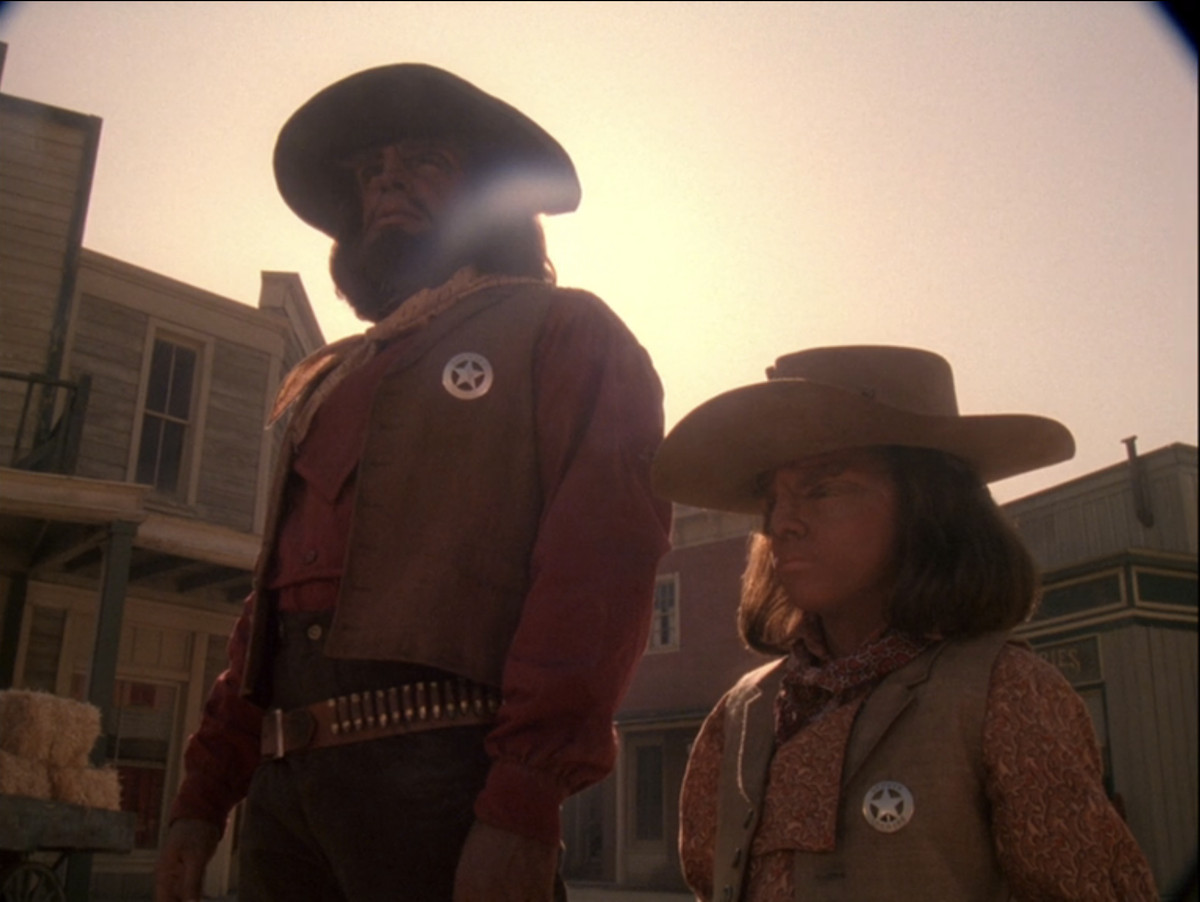Worf (Michael Dorn) and a smaller Klingon child in Wild West garb