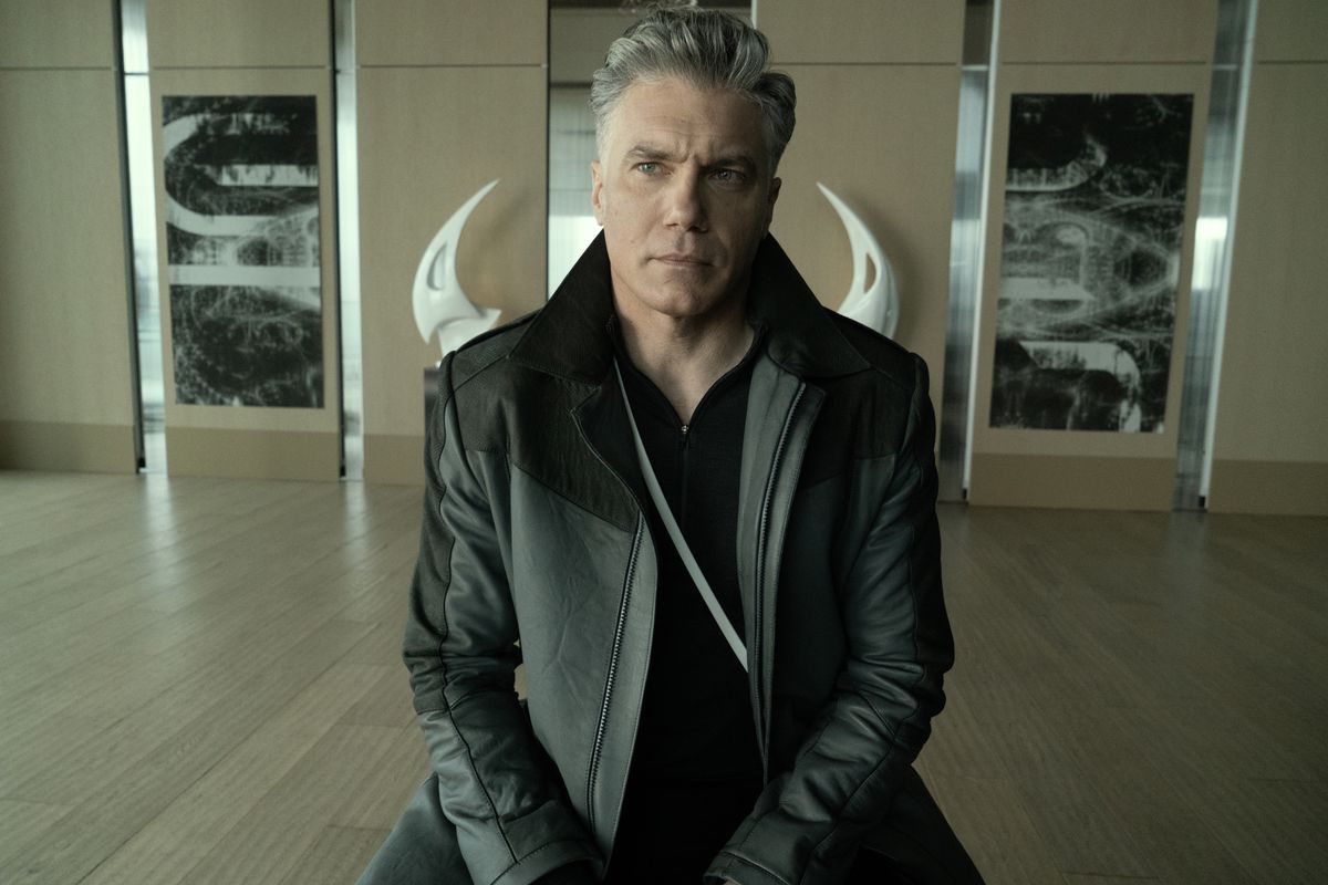 Anson Mount as Capt. Pike in episode 202 “Ad Astra per Aspera” of Star Trek: Strange New Worlds. Hes sitting in a chair in a large wood-paneled room. 