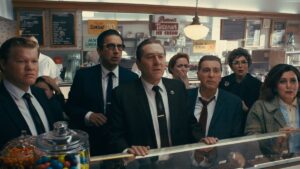 several people in suits and dresses stand in an ice cream shop and look horrified
