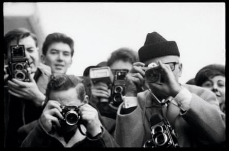 Slovak photographer and friend of the band Dezo Hoffmann (on right), among the throng in Paris