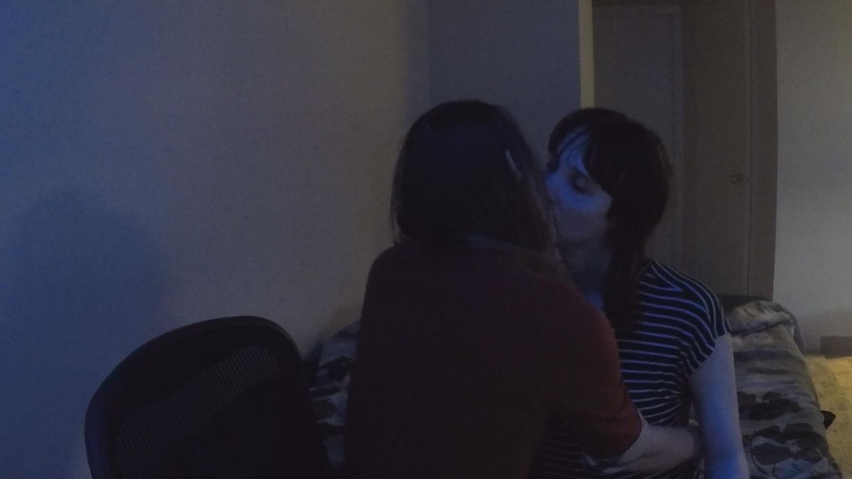 Narcissa Wright and Alex Eastly (aka d_gurl) kiss on a bed in a dark room in a shot taken from a Twitch stream in the documentary Break the Game.