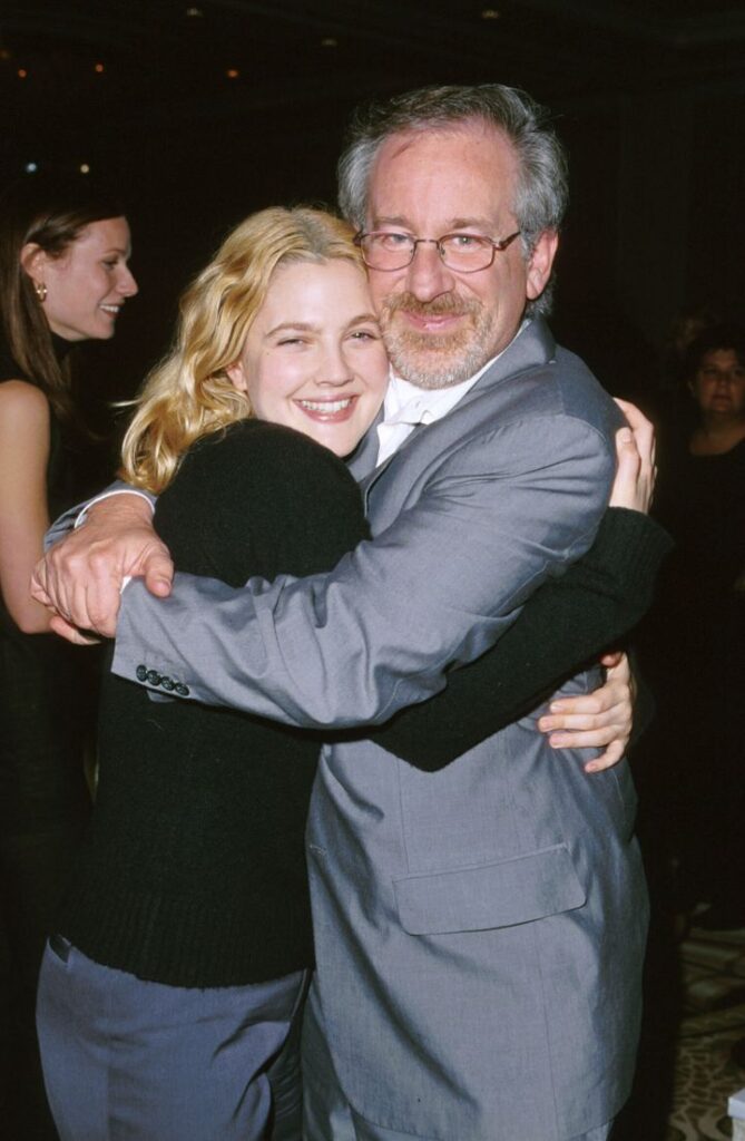 Actor Drew Barrymore hugs director Steven Spielberg.