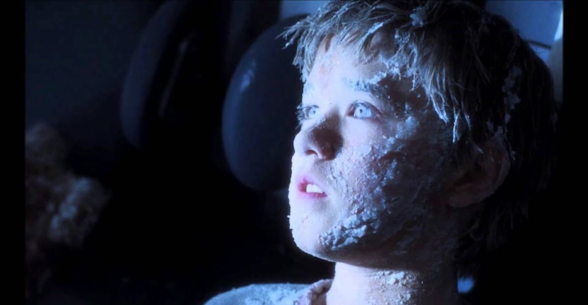The robot David, who looks like a small child (played by Haley Joel Osment) with ice in his hair, on his face, and in his eyes in Steven Spielberg’s A.I. Artificial Intelligence