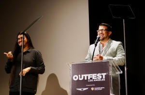 Outfest Executive Director Damien Navarro, with sign language interpreter at left.