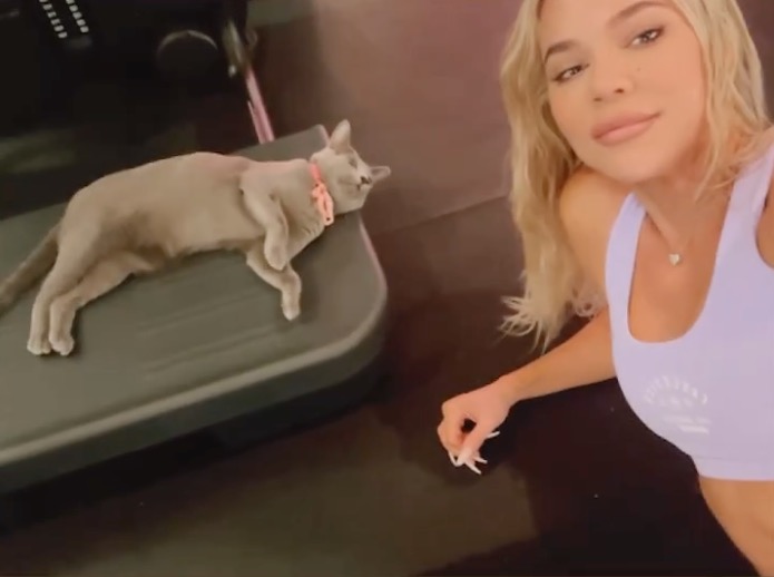 As Khloe sweated it out her daughter True's cat enjoyed a stretch