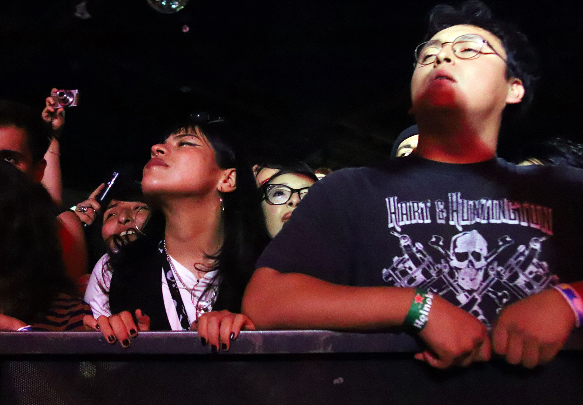 Two people watch a band perform.