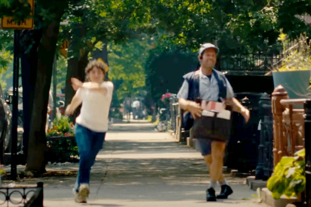 Claud Mintz and Paul Rudd dance down a street in the music video. 