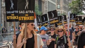 SAG-AFTRA picketers hold signs on a picket line