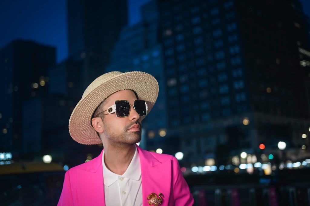 Dj Cassidy in pink jacket and wide-brimmed hat. 