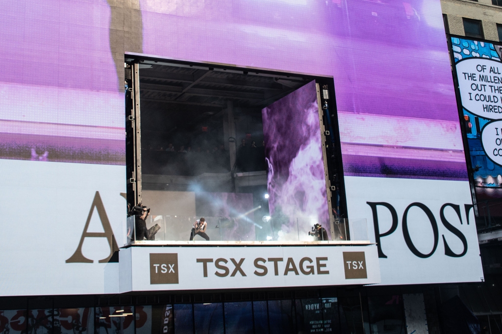 Post Malone performs in the TSX billboard.