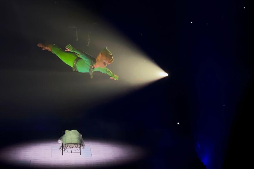Peter Pan on a stage with a bed