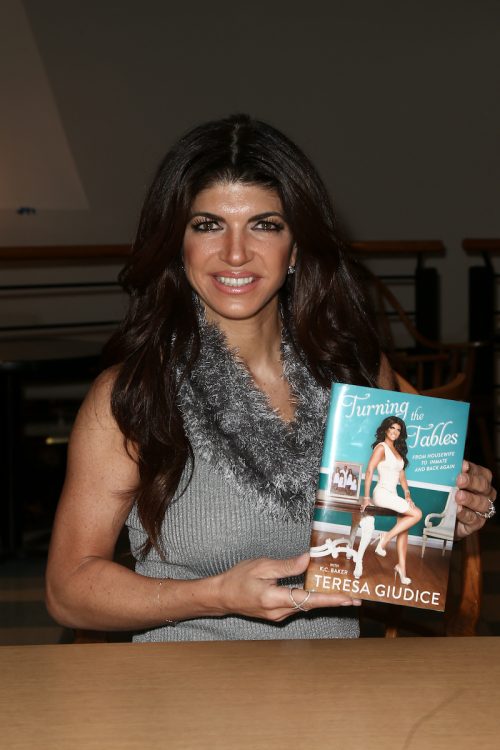 Teresa Giudice posing with her book 
