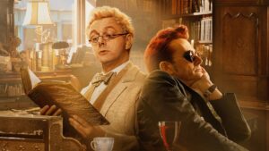 Aziraphale and Crowley sit next to each other in a bookshop in the poster for Good Omens season 2