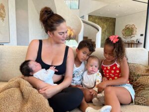 Chrissy Teigen will all four of her babies