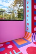 Inside the Discoteca kiosk with a waist-high window, the word “Dancing” on the wall and large rubberised squares on the floor