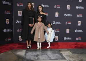 Vanessa Bryant stands with daughters Natalia, Bianka and Capri, on the red carpet.