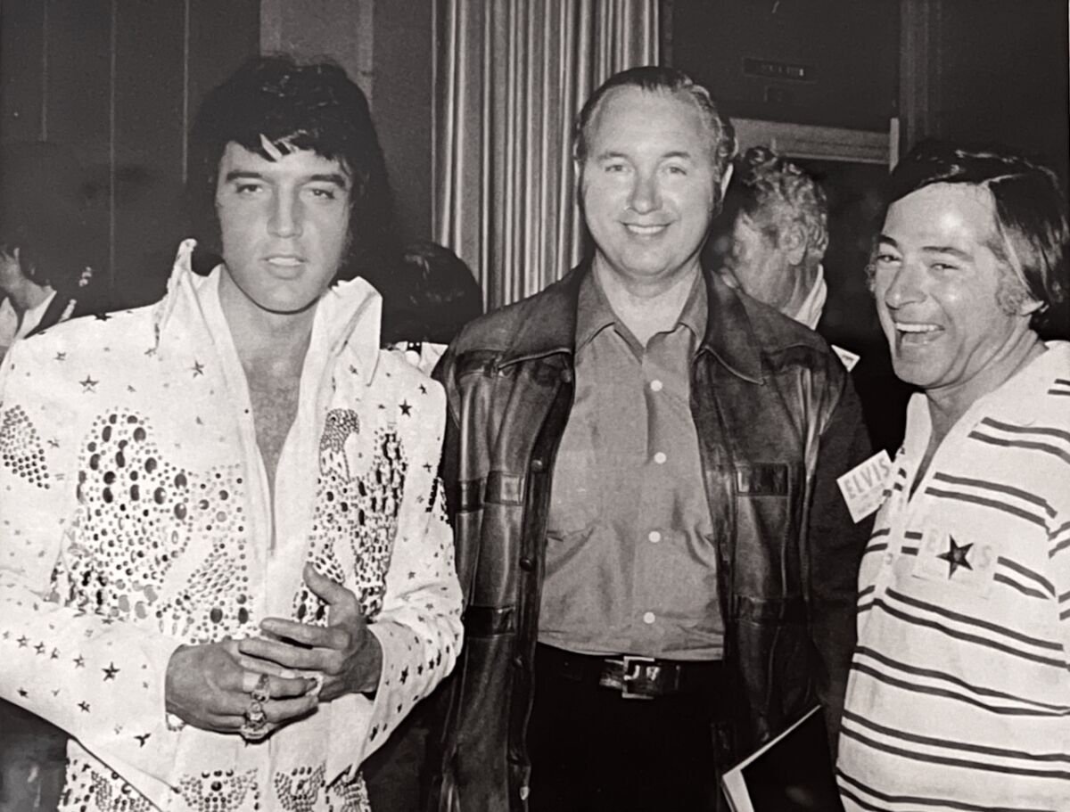 Elvis Presley and two TV executives in 1973.
