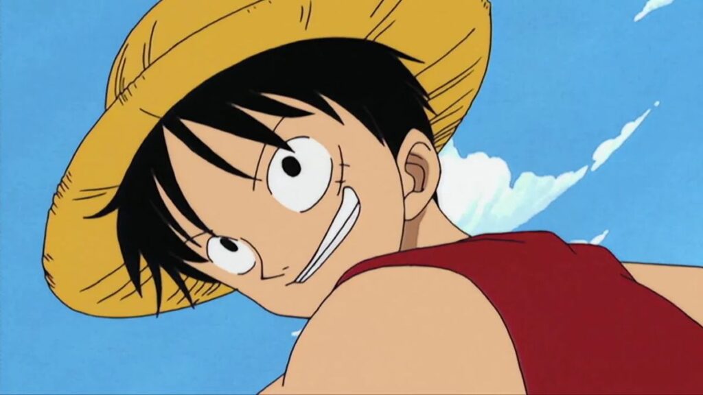 Luffy looking back over his shoulder and smiling in a still from an early episode of One Piece