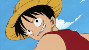 Luffy looking back over his shoulder and smiling in a still from an early episode of One Piece