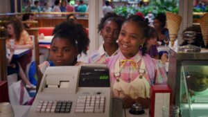 Erica Sinclair and her friends stand at the retail cash register for scoops ahoy in Netflix show stranger things