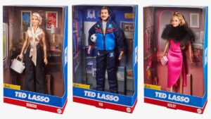 Ted Lasso Barbie dolls all on display in their boxes at an angle: Rebecca, Ted, and Keeley