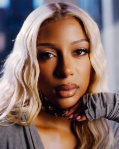 A portrait of a female R&B singer with blond hair