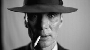 cillian Murphy in a hat with a cigarette dangling from hhis mouth in Oppenheimer