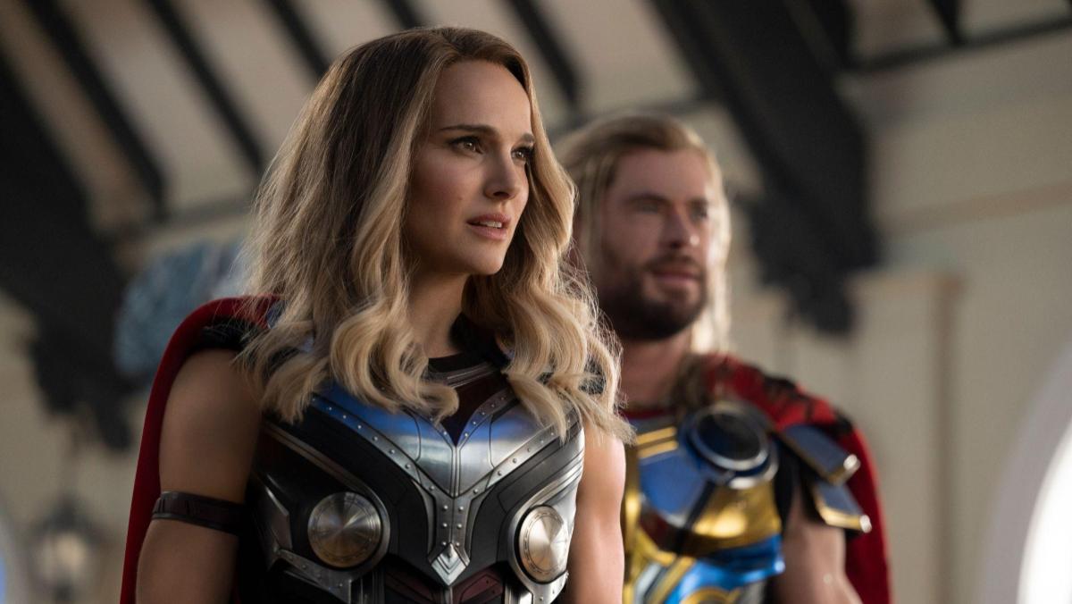 An image from Thor Love and Thunder shows Natalie Portman as Jane Foster in her Mighty Thor costume and Chris Hemsworth in his Thor costume