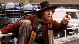 Fourth Doctor stands in front of two Daleks and points classic doctor who on tubi