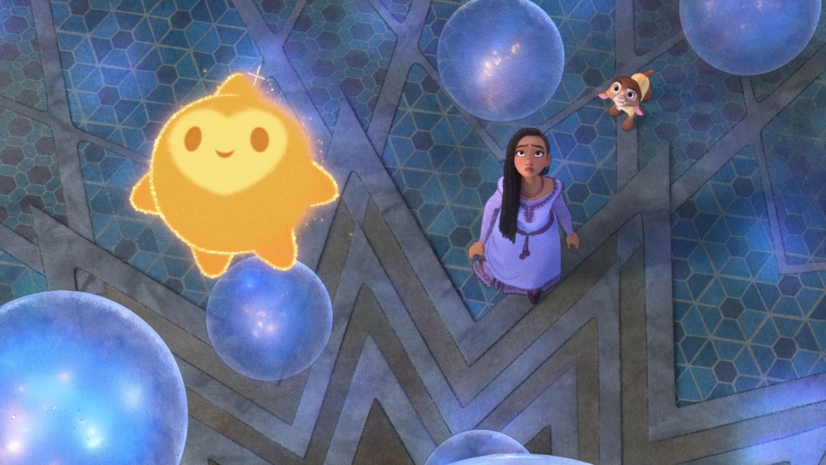 A yellow Star floats up among blue orbs while Asha and her goat look at him in Disney's Wish