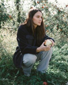 Abbie Herbert poses for a photo during an apple-picking trip in 2023