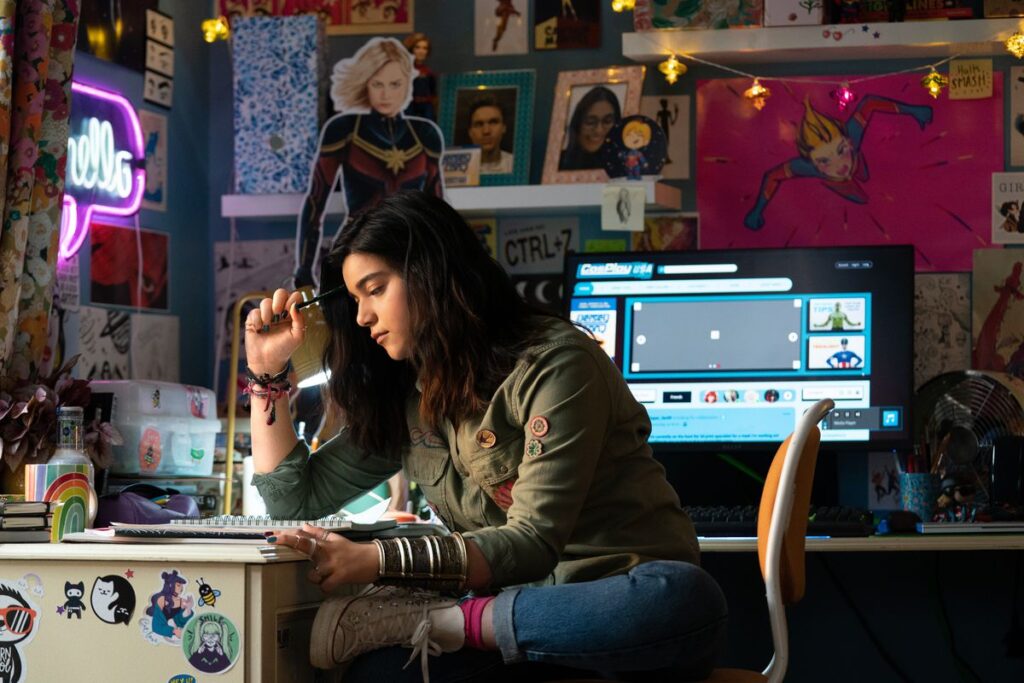 Kamala Khan sits at her desk at home in The Marvels.