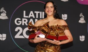 Rosalia poses with four of the eight Latin Grammy awards she won in 2022.