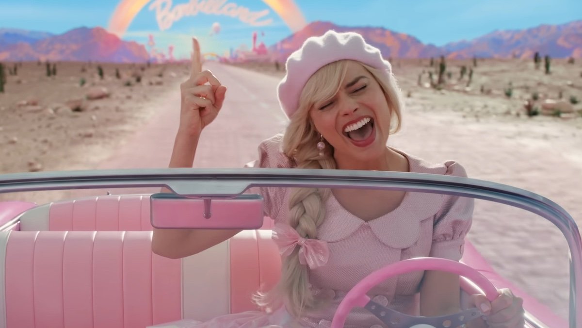 Margot Robbie's Barbie in pink sings while driving her pink car