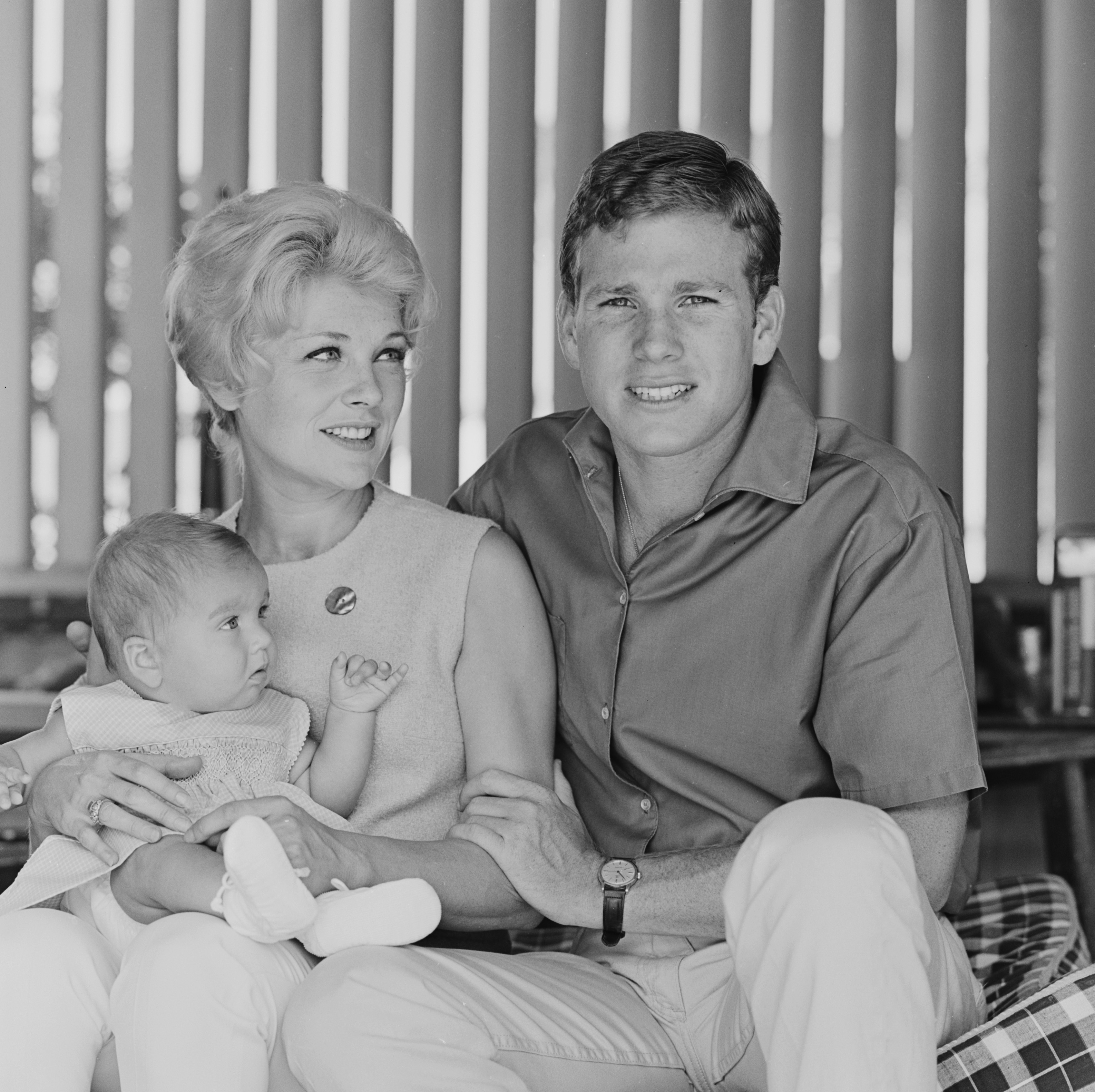 Joanna Moore and Ryan O’Neal at home with their daughter, Tatum O'Neal behind the scenes during the making of the ABC TV series Peyton Place in 1964