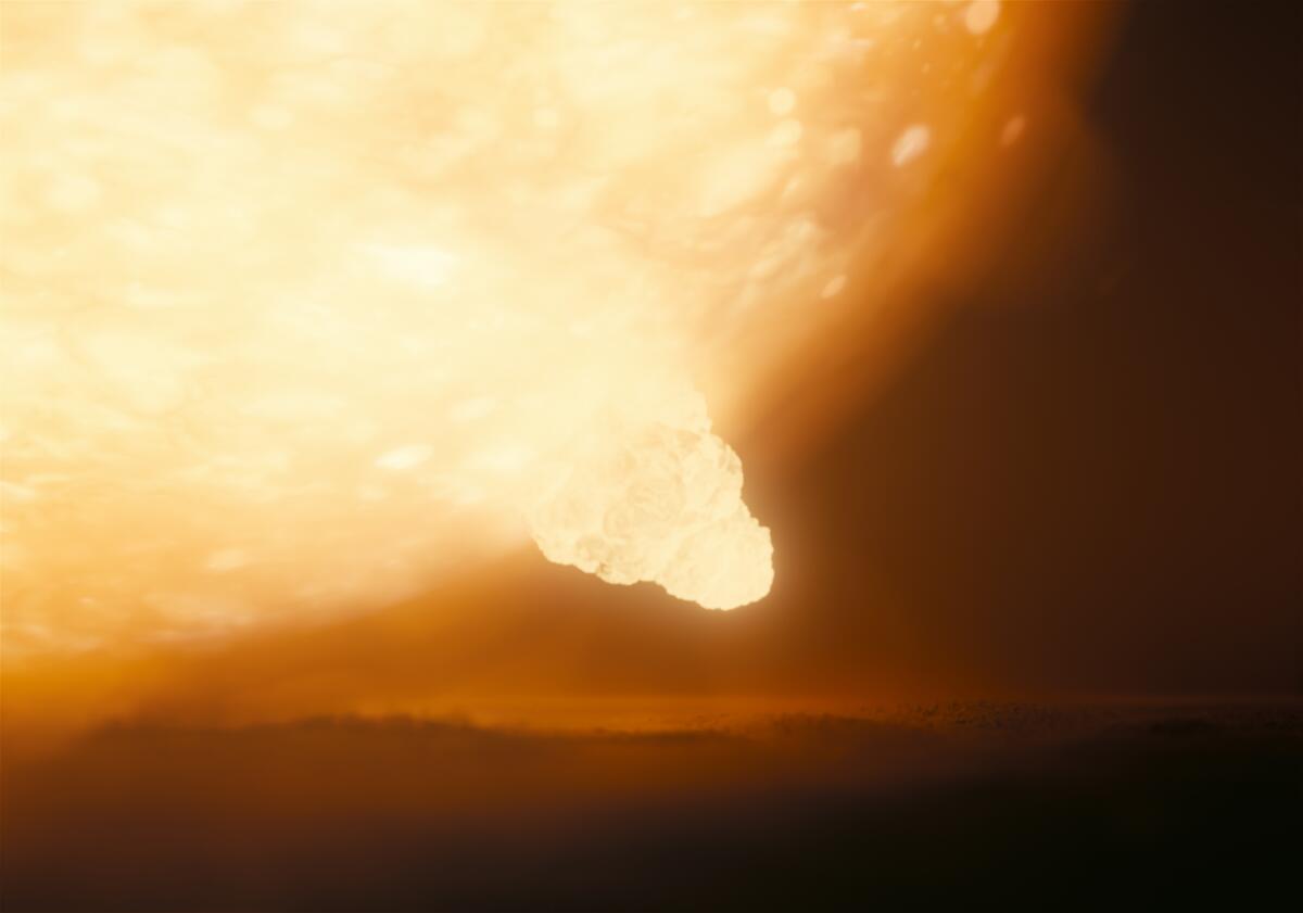 A giant fireball fills the sky in a scene from "Oppenheimer."