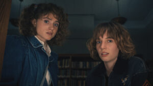 Nancy and Robin look surprised in a still from Stranger Things 4