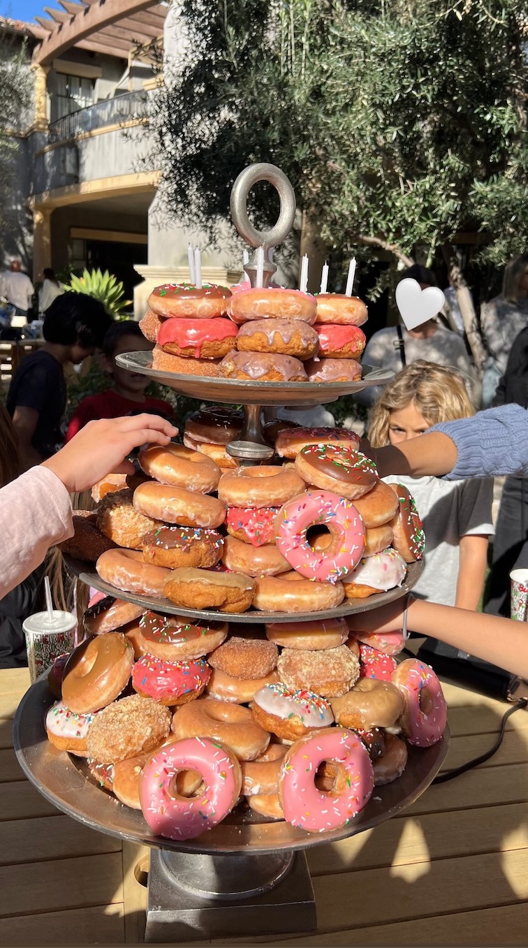 The Hulu star shared a photo of the three-tiered doughnut cake, with several little hands reaching in to take one of the delicious treats