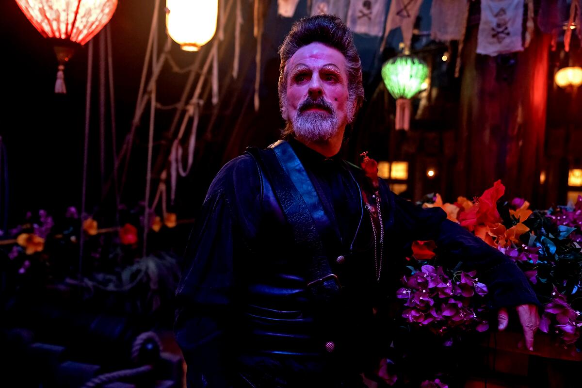 A man with stage makeup on stands amid colorful lanterns in "Our Flag Means Death"