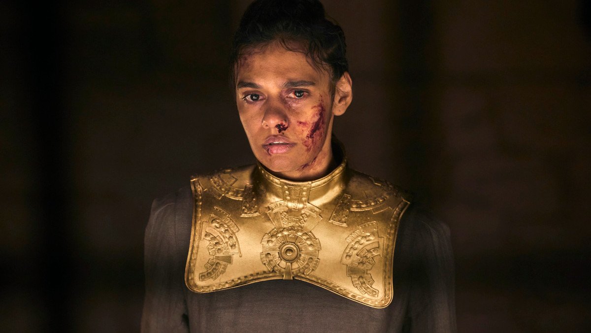 Egwene as a collared damane, bloodied and bruised on a dark background
